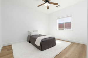 Bedroom with visible vents, baseboards, and light wood-type flooring