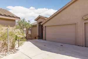 View of side of property featuring stucco siding and a tiled roof