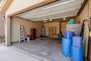 Garage with a garage door opener and refrigerator