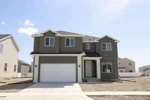 View of front of property featuring an attached garage, roof with shingles, fence, and concrete driveway