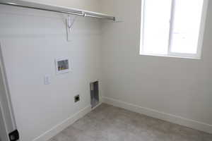 Washroom with laundry area, hookup for a washing machine, baseboards, and hookup for an electric dryer