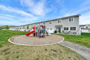 Community playground with an outdoor hangout area, a lawn, and central AC