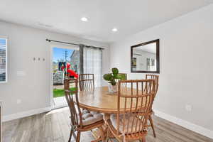 Dining room with baseboards, recessed lighting, light wood-style flooring, and visible vents