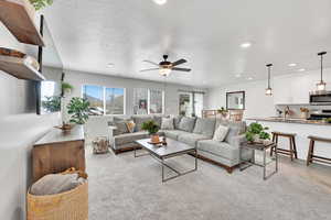Living area with recessed lighting, ceiling fan, a healthy amount of sunlight, and a textured ceiling