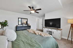 Bedroom with baseboards, ceiling fan, and light carpet