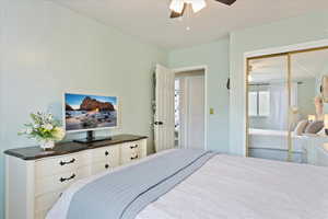 Bedroom with a ceiling fan and a closet