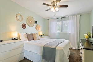 Bedroom with a ceiling fan and carpet flooring