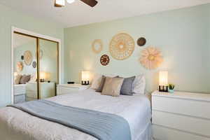 Bedroom featuring a ceiling fan and a closet