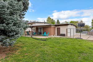 Back of house featuring a yard, a patio, and fence
