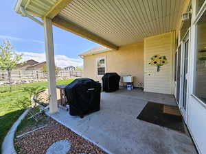 Backyard covered patio with gas grill