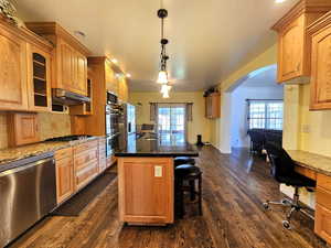 Kitchen leading straight to sunroom/living space, with high archway to family room on right