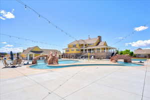 Community pool with a patio area and fence