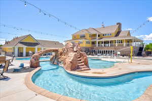 Community pool featuring fence and a patio area