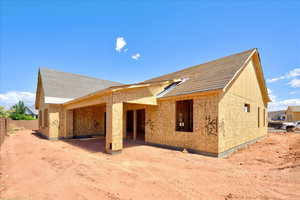Rear view of property featuring fence