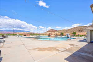 Pool featuring a mountain view and a patio area