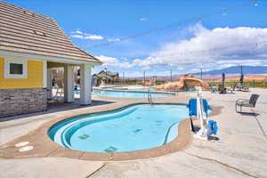 Community pool featuring fence, a mountain view, and a patio area