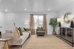 Living area with recessed lighting and baseboards