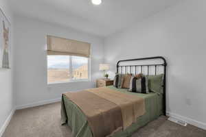 Bedroom with visible vents, baseboards, and carpet floors
