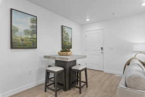 Dining area featuring recessed lighting, baseboards, light wood finished floors, and visible vents
