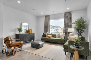 Living area featuring recessed lighting, baseboards, and wood finished floors