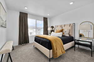 Carpeted bedroom featuring baseboards, recessed lighting, and visible vents