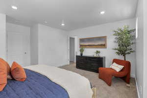 Bedroom featuring baseboards, light carpet, and recessed lighting