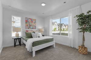 Bedroom featuring carpet floors, multiple windows, and baseboards