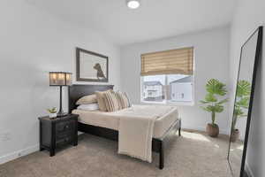 Carpeted bedroom featuring baseboards