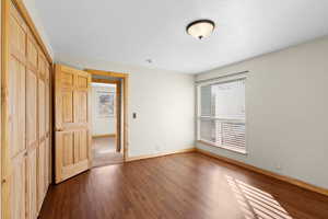 Unfurnished bedroom featuring a closet and wood finished floors