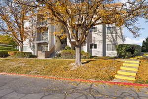 View of front of house with stairs and a balcony