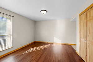 Unfurnished bedroom featuring light wood finished floors and a closet