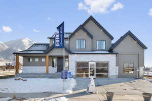Exterior space featuring a mountain view and stone siding
