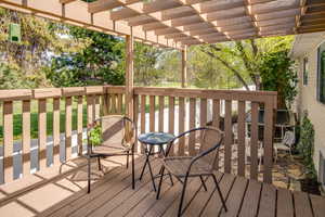 Deck with a pergola with Golf Course Behind.