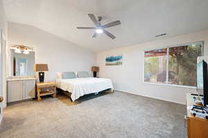 Bedroom with ceiling fan, light carpet, baseboards, lofted ceiling, and visible vents