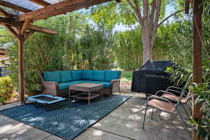 View of patio / terrace featuring a pergola, an outdoor hangout area, and a grill
