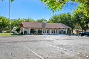 View of property featuring uncovered parking