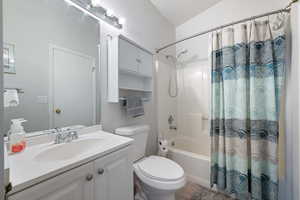 Bathroom featuring vanity, toilet, wood finished floors, and shower / tub combo