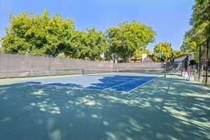 View of tennis court with fence