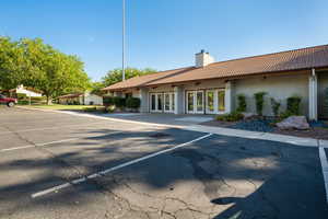 View of building exterior featuring uncovered parking