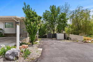 WEST DRIVEWAY TO GARAGES RV PAD  and BACKYARD