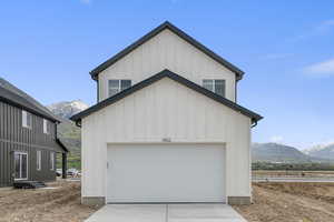 Garage featuring concrete driveway and a mountain view