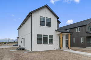 Modern inspired farmhouse with a mountain view and board and batten siding