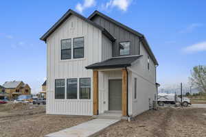 Modern inspired farmhouse featuring board and batten siding