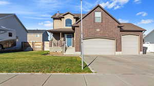 Traditional-style house featuring covered porch, a front yard, brick siding, concrete driveway, and an attached garage