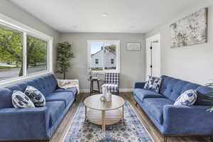 Living area featuring baseboards, recessed lighting, and wood finished floors