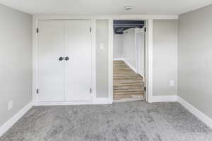 Unfurnished bedroom featuring baseboards, carpet, and multiple closets