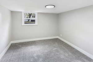 Below grade area featuring carpet floors and baseboards