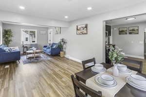 Dining room with baseboards, recessed lighting, and light wood-style flooring