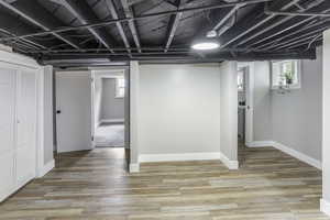 Basement featuring baseboards and light wood-style floors