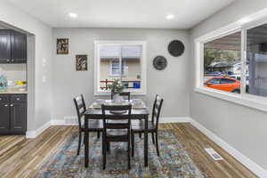 Dining area with baseboards, visible vents, and light wood finished floors